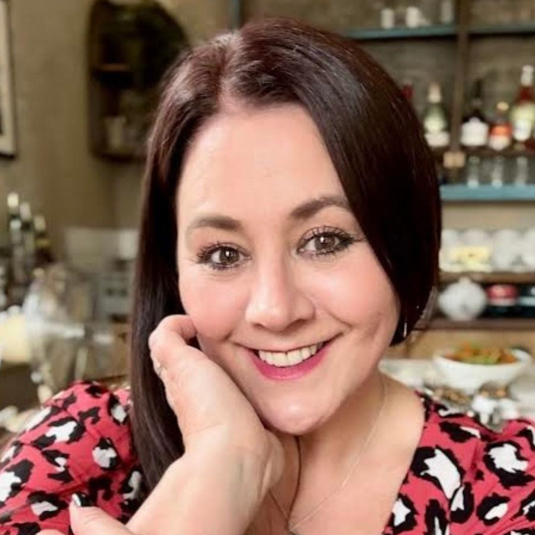Woman with a leopard print top in a casual setting