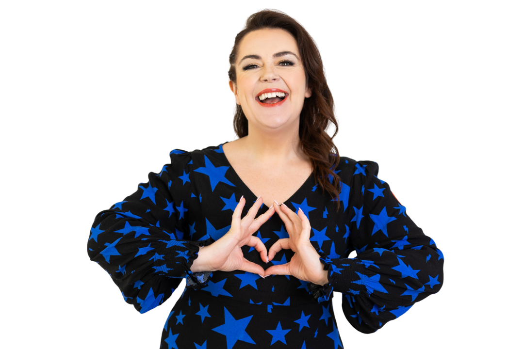 Woman wearing a black dress with blue star patterns, making a heart shape with her hands on a white background